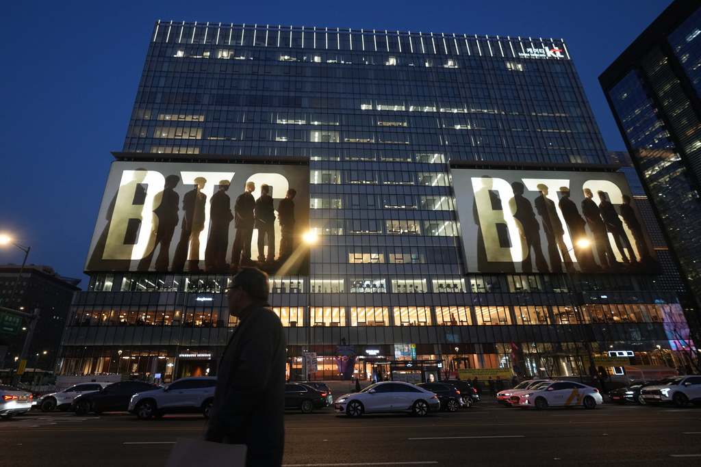 K-pop band BTS is displayed on big screens on a building in downtown Seoul, South Korea, Monday, March 16, 2026. (AP Photo/Lee Jin-man)