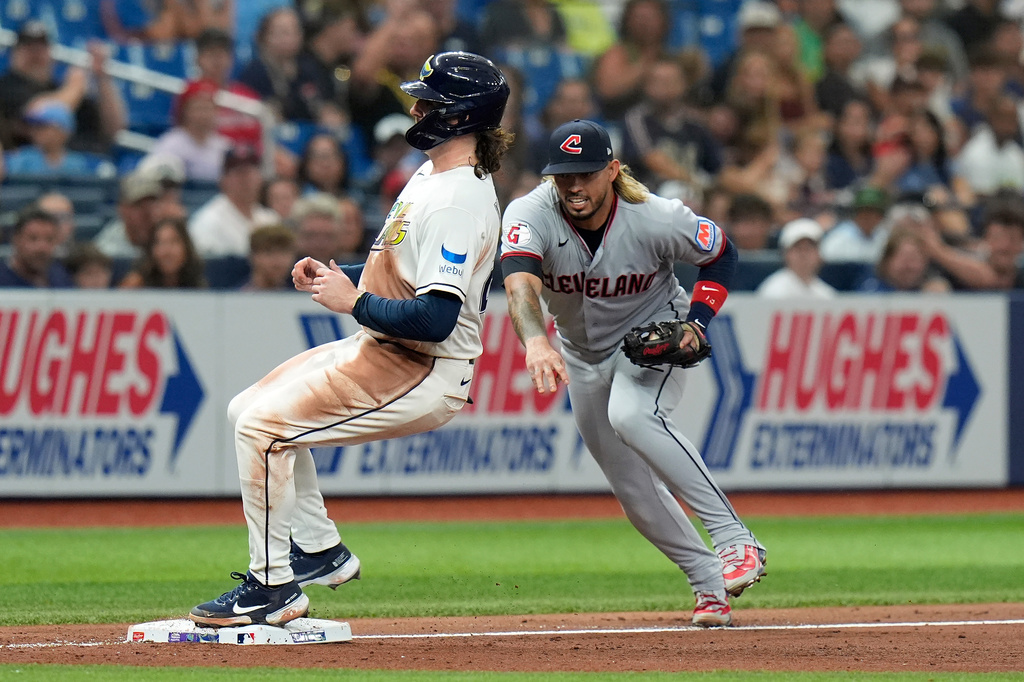 Tampa Bay Rays' Ryan Vilade, left, beats Cleveland Guardians third baseman Gabriel Arias to the base after a RBI single by Nick Fortes during the fourth inning of a baseball game Friday, July 24, 2026, in St. Petersburg, Fla. (AP Photo/Chris O'Meara)