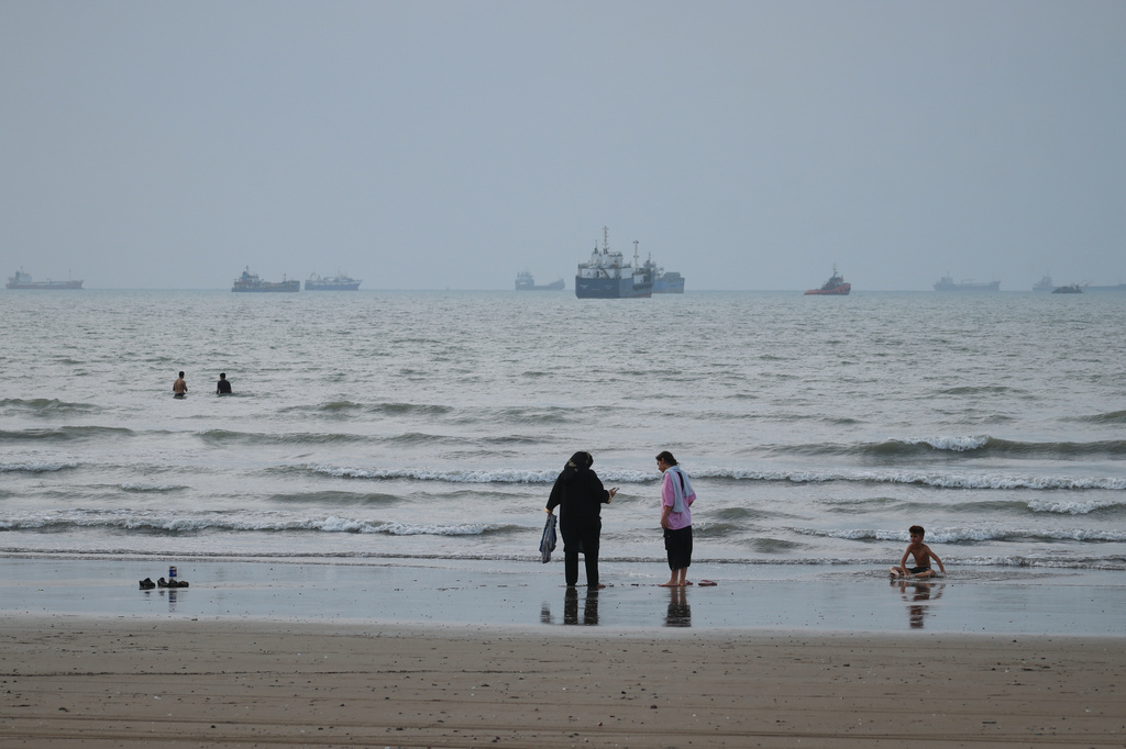 People spend time at a beach as commercial vessels are anchored in the Strait of Hormuz off Bandar Abbas, Iran, Wednesday, Sept. 2, 2026. (Razieh Poudat/ISNA via AP)