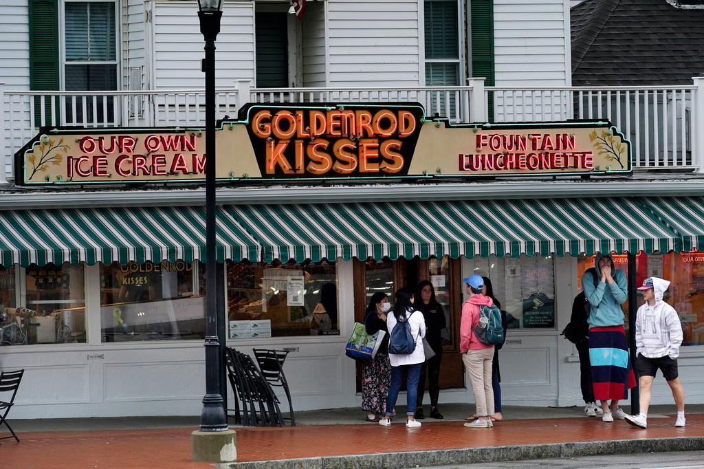 FILE - High school students gather outside The Goldenrod, a popular restaurant and candy shop, Wednesday, June 1, 2022, in York Beach, Maine. (AP Photo/Robert F. Bukaty, File)