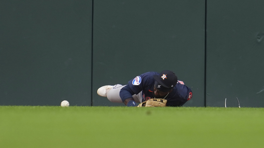 Houston Astros center fielder Taylor Trammell is injured attempting to catch a Detroit Tigers' Dillon Dingler fly ball in the first inning during a baseball game Wednesday, Aug. 20, 2025, in Detroit. (AP Photo/Paul Sancya)