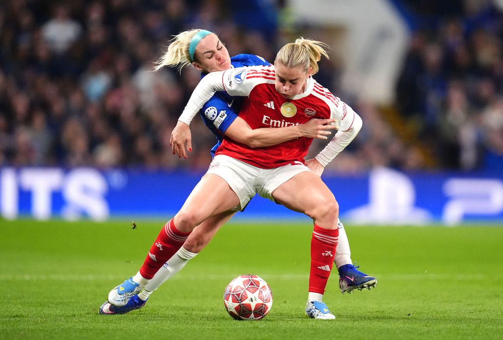 Arsenal's Alessia Russo, left, and Chelsea's Ellie Carpenter battle for the ball during the Women's Champions League quarterfinal second leg soccer match between Chelsea and Arsenal in London, Wednesday, April 1, 2026. (John Walton/PA via AP)