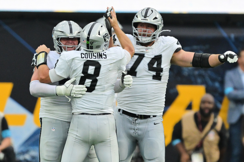 Las Vegas Raiders quarterback Kirk Cousins (8) celebrates with teammates after throwing a touchdown pass to wide receiver Cody White during the second half of an NFL football game against the Los Angeles Chargers in Inglewood, Calif., Sunday, Sept. 20, 2026. (AP Photo/Jayne Kamin-Oncea)