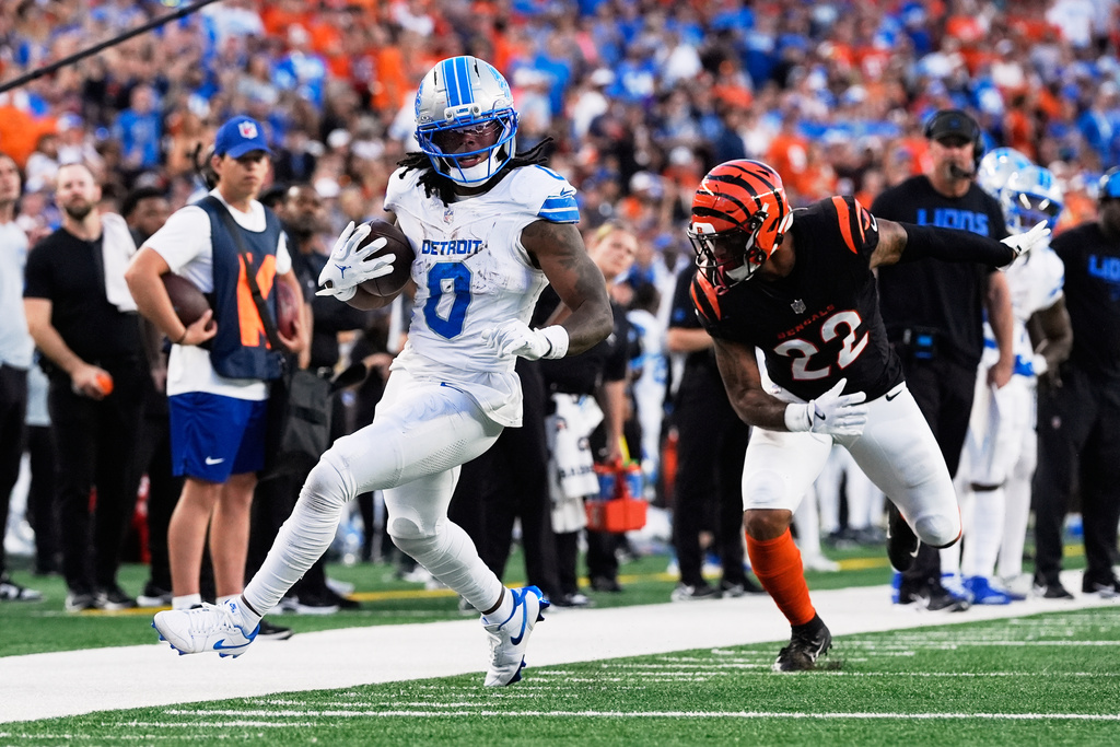 Detroit Lions running back Jahmyr Gibbs (0) runs past Cincinnati Bengals safety Geno Stone (22) during the second half of an NFL football game Sunday, Oct. 5, 2025, in Cincinnati. (AP Photo/Carolyn Kaster)