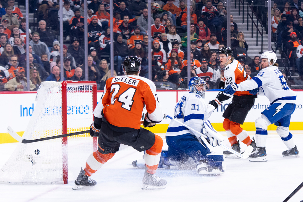 Philadelphia Flyers' Christian Dvorak, center right, shot gets past Tampa Bay Lightning's Jonas Johansson, center left, for a goal during the second period of an NHL hockey game, Monday, Jan. 12, 2026, in Philadelphia. (AP Photo/Chris Szagola)