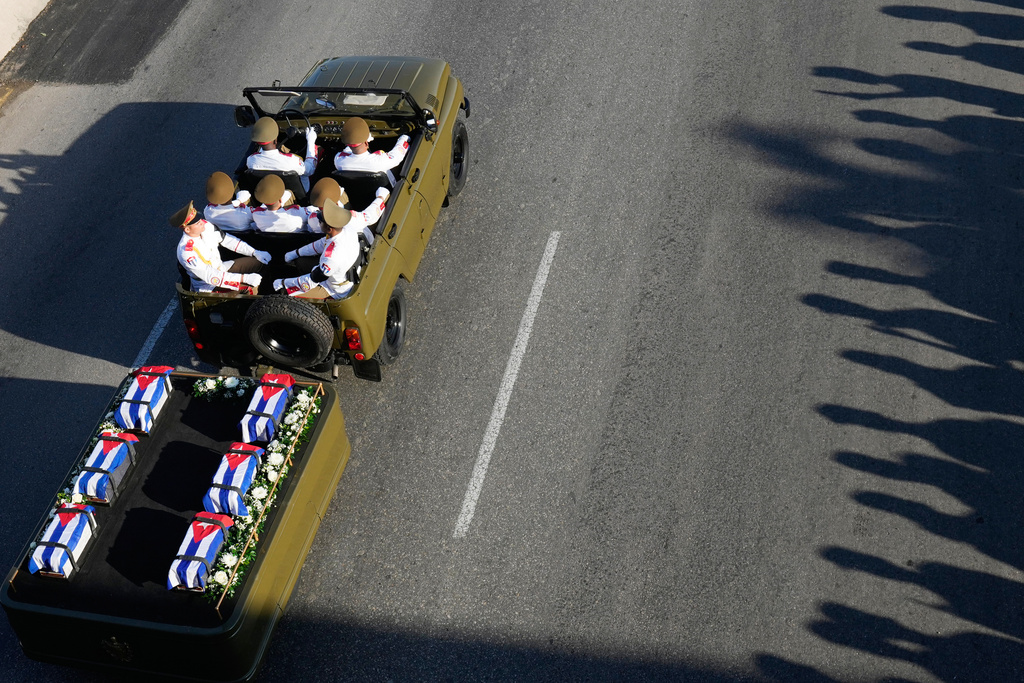 A motorcade transports urns containing the remains of Cuban officers, who were killed during the U.S. operation in Venezuela that captured Venezuelan President Nicolas Maduro, through Havana, Cuba, Thursday, Jan. 15, 2026. (AP Photo/Ramon Espinosa)