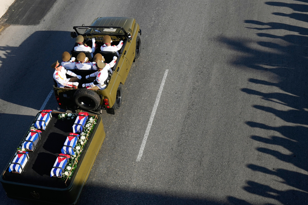 A motorcade transports urns containing the remains of Cuban officers, who were killed during the U.S. operation in Venezuela that captured Venezuelan President Nicolas Maduro, through Havana, Cuba, Thursday, Jan. 15, 2026. (AP Photo/Ramon Espinosa)