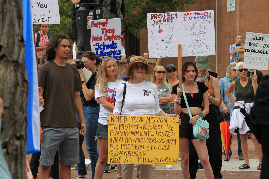Protesters gather outside a state office to voice opposition to the Project Jupiter data center during a demonstration in Santa Fe, N.M., Friday, Aug. 21, 2026. (AP Photo/Susan Montoya Bryan)