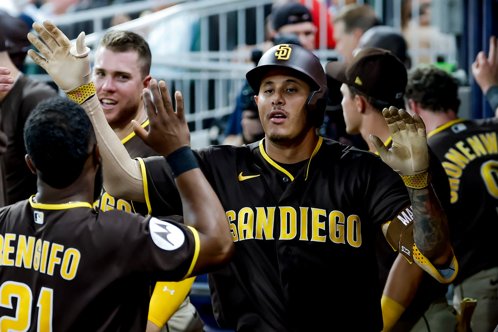 San Diego Padres' Manny Machado is greeted in the dugout after hitting a solo home run against the Atlanta Braves during the sixth inning of a baseball game, Tuesday, July 21, 2026, in Atlanta. (AP Photo/Erik S. Lesser)