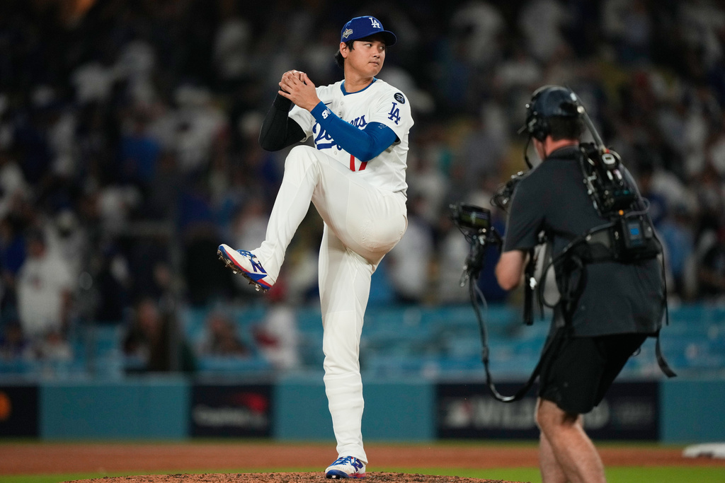 Los Angeles Dodgers' Shohei Ohtani makes a pitching motion on the mound after a win over the Cincinnati Reds in Game 1 of the National League Wild Card baseball playoff series Tuesday, Sept. 30, 2025, in Los Angeles. (AP Photo/Mark J. Terrill)