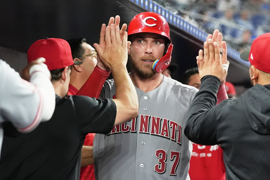 Cincinnati Reds' Tyler Stephenson (37) is congratulated in the dugout after scoring on a a double hit by Matt McLain during the 10th inning of a baseball game against the Miami Marlins, Tuesday, April 7, 2026, in Miami. (AP Photo/Lynne Sladky)