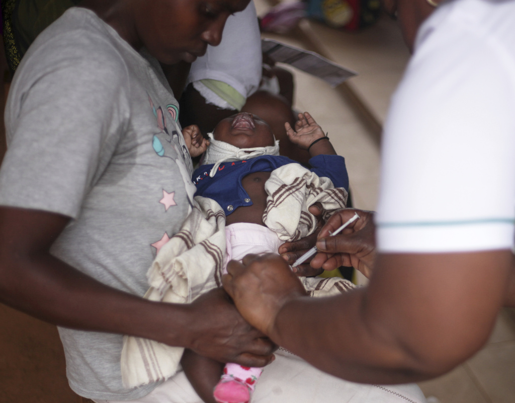 A child receives a vaccine shot at Wakiso Health Centre IV in Wakiso, Uganda, Wednesday, July 23, 2025. (AP Photo/Patrick Onen)