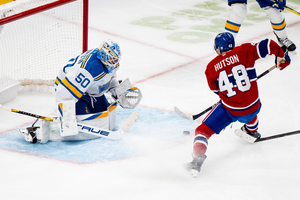 Montreal Canadiens' Lane Hutson (48) scores on St. Louis Blues goaltender Jordan Binnington (50) during the first period of an NHL hockey hgame, in Montreal, Sunday, Dec. 7, 2025. (Christopher Katsarov/The Canadian Press via AP)