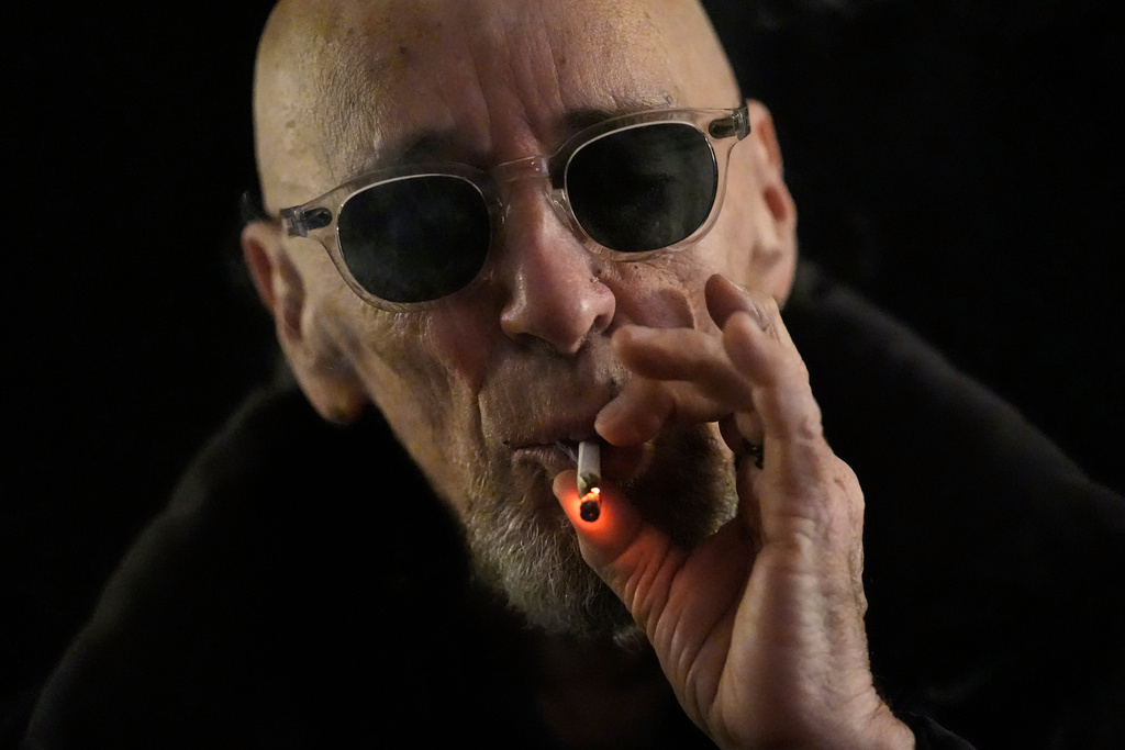 Miguel Laboy takes a hit of a joint Friday, Nov. 14, 2025, in Brookline, Mass. (AP Photo/Robert F. Bukaty)