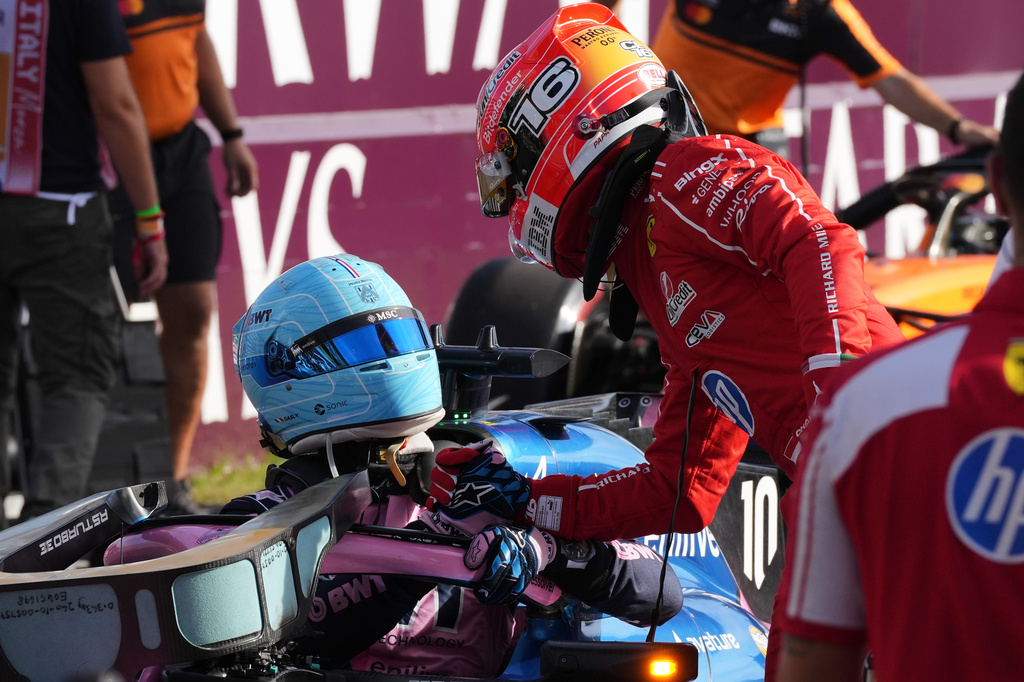 Ferrari driver Charles Leclerc of Monaco, right, congratulates Alpine driver Pierre Gasly of France, left, for his pole position after the qualifying session ahead of the Italian Formula One Grand Prix, in Monza, Italy, Saturday, Sept. 5, 2026. (AP Photo/Antonio Calanni)