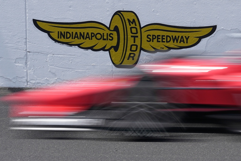 FILE - A car goes by the Indianapolis Motor Speedway logo during practice for the Indianapolis 500 auto race at Indianapolis Motor Speedway, May 22, 2023, in Indianapolis. (AP Photo/Darron Cummings, File)