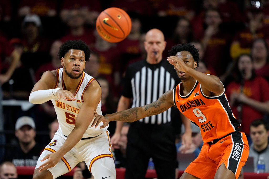 Iowa State forward Joshua Jefferson (5) passes over Oklahoma State guard Anthony Roy (9) during the first half of an NCAA college basketball game, Saturday, Jan. 10, 2026, in Ames, Iowa. (AP Photo/Charlie Neibergall)