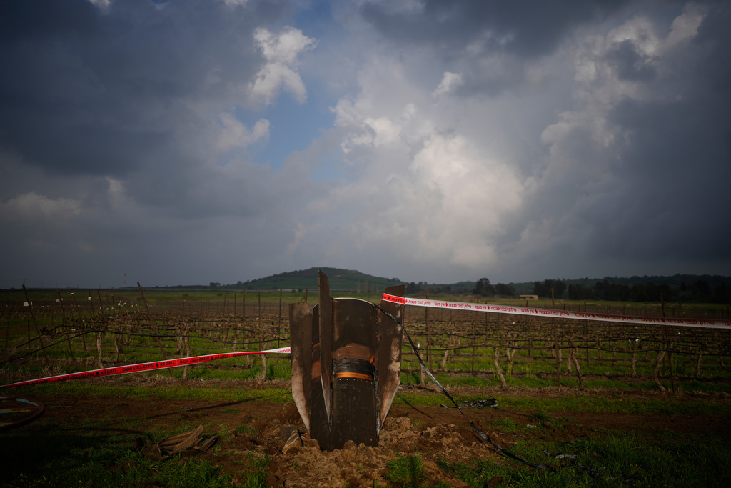 Fragment of a missile fired from Iran, and intercepted by Israeli defense system, sticks out in a open field in the Israeli-controlled Golan Heights, Thursday, March 19, 2026. (AP Photo/Ohad Zwigenberg)