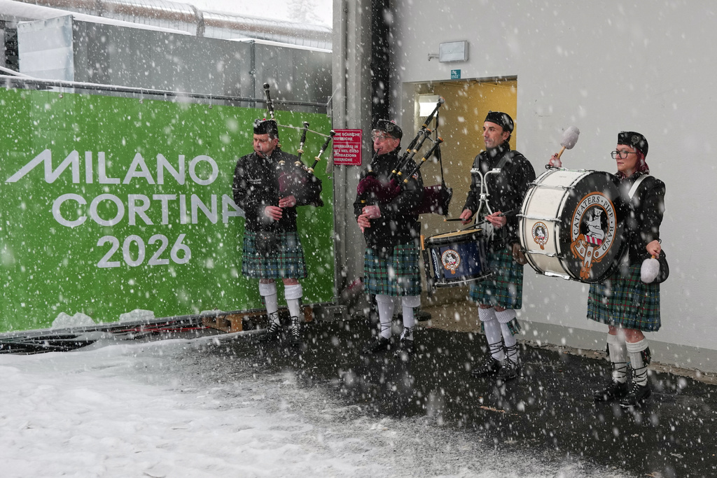 Italian bagpipers practice outside the curling stadium, at the 2026 Winter Olympics, in Cortina d'Ampezzo, Italy, Thursday, Feb. 19, 2026. (AP Photo/Misper Apawu)