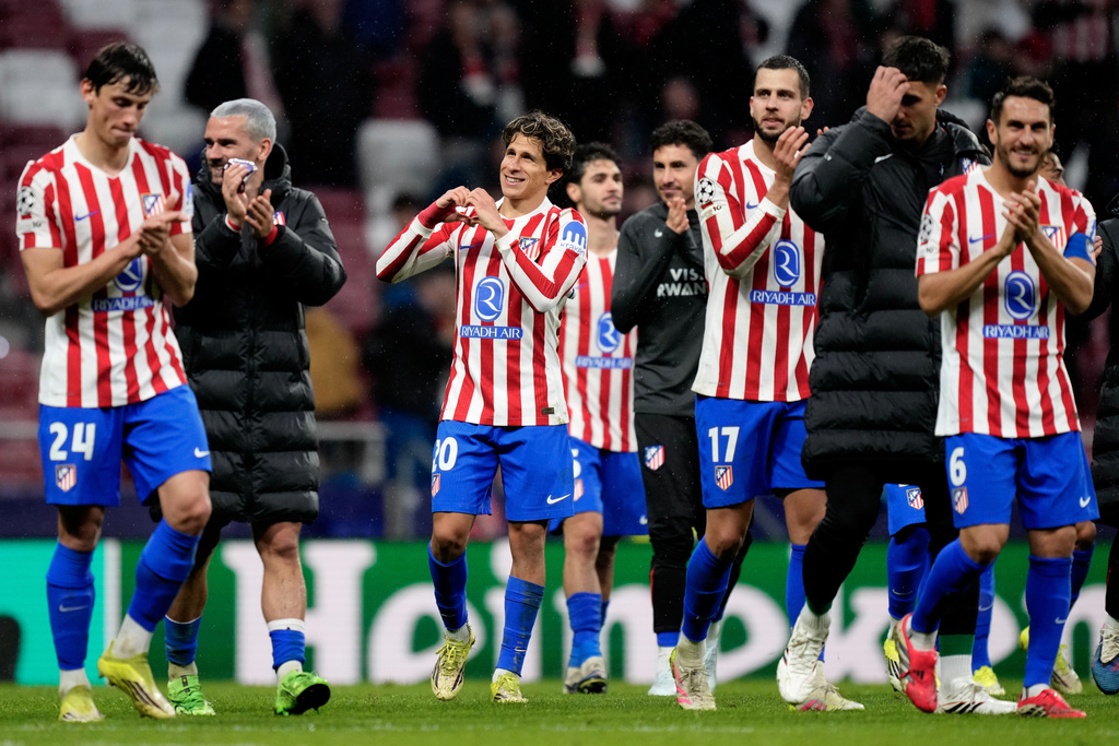 Atletico Madrid players greet fans at the end of the first leg of the Champions League round of 16 soccer match between Atletico Madrid and Tottenham in Madrid, Spain, Tuesday, March 10, 2026. (AP Photo/Jose Breton)