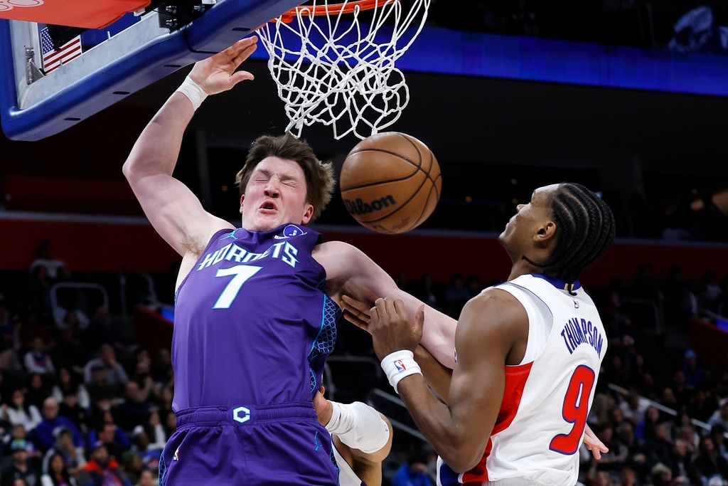 Charlotte Hornets guard Kon Knueppel (7) dunks against Detroit Pistons guard Ausar Thompson (9) during the first half of an NBA basketball game Saturday, Dec. 20, 2025, in Detroit. (AP Photo/Duane Burleson)