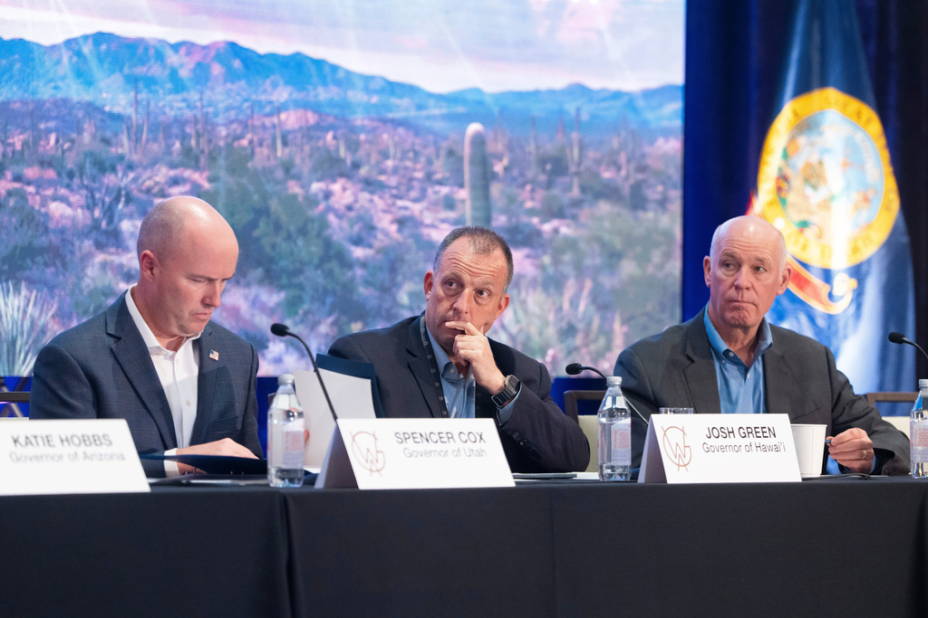 Utah Gov. Spencer Cox, Hawaii Gov. Josh Green and Montana Gov. Greg Gianforte listen during the Western Governors' Association meeting Thursday, Nov. 20, 2025, in Scottsdale, Ariz. (AP Photo/Rebecca Noble)