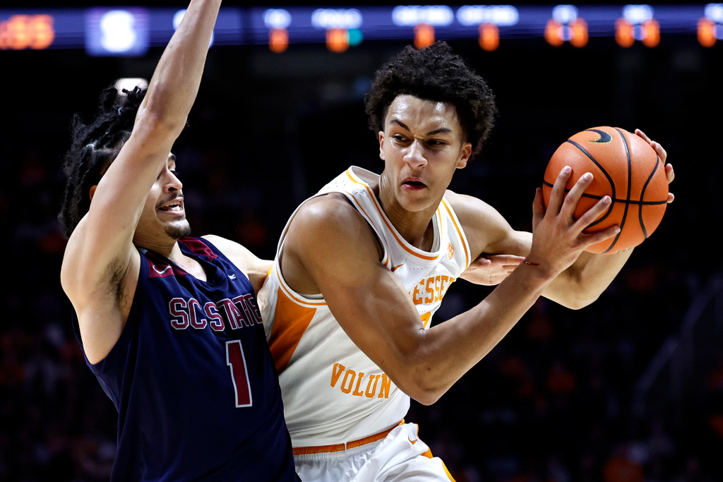 Tennessee forward Nate Ament (10) drives for a shot as he's defended by South Carolina State guard Florian Tenebay (1) during the first half of an NCAA college basketball game Tuesday, Dec. 30, 2025, in Knoxville, Tenn. (AP Photo/Wade Payne)