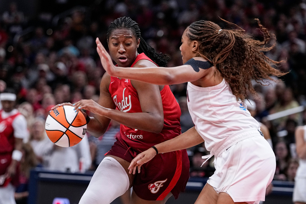 Indiana Fever center Aliyah Boston, left, drives on Atlanta Dream forward Naz Hillmon in the first half of a WNBA basketball game in Indianapolis, Thursday, June 18, 2026. (AP Photo/Michael Conroy)
