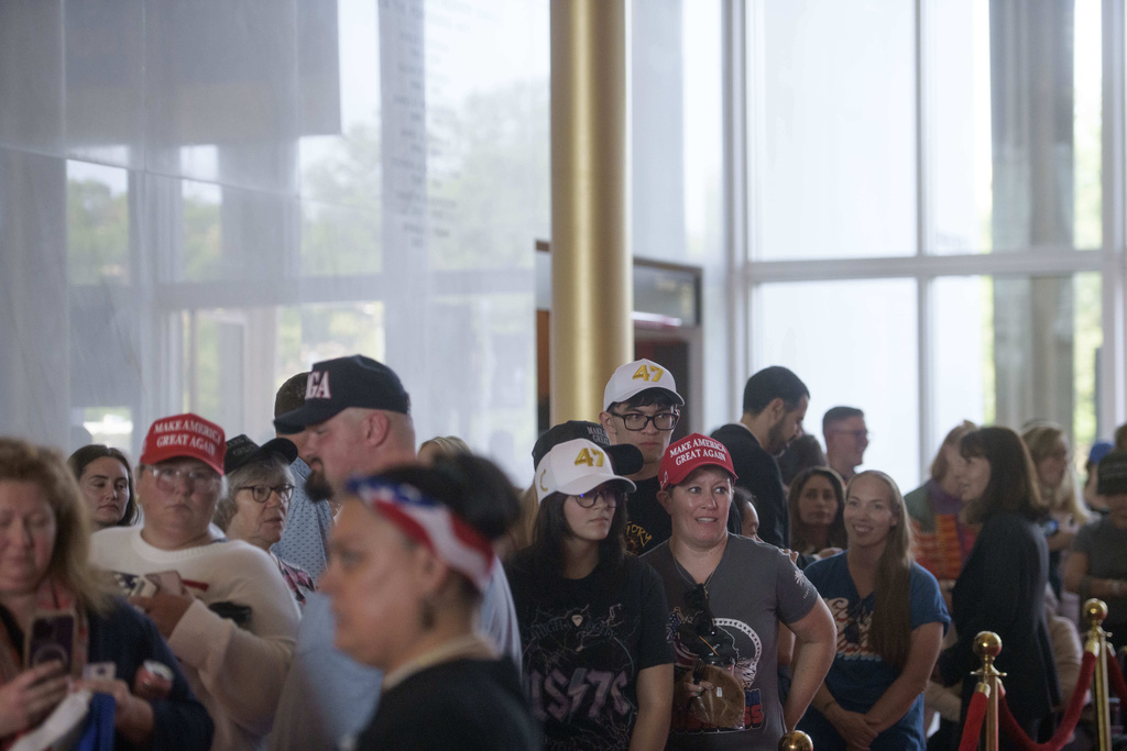 People wait in line for a memorial and prayer vigil for Charlie Kirk at the John F. Kennedy Memorial Center for the Performing Arts, Sunday, Sept. 14, 2025, in Washington. (AP Photo/Rod Lamkey, Jr.)