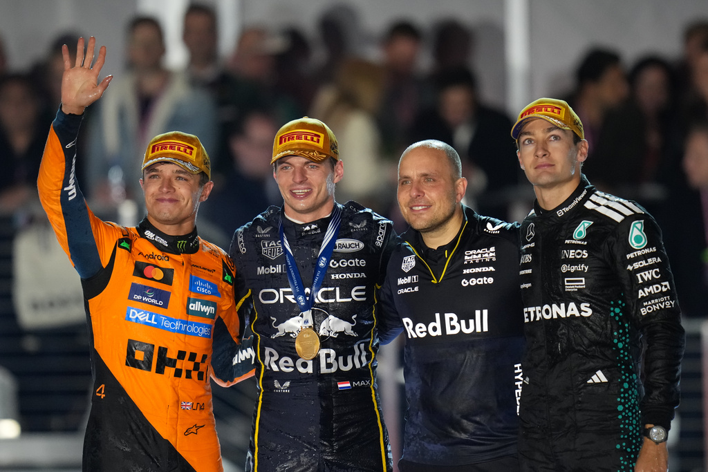 From left, second place finisher McLaren driver Lando Norris of Great Britain, first place finisher Red Bull driver Max Verstappen of the Netherlands, Verstappen's chief race engineer Gianpiero Lambiase, and third place finisher Mercedes driver George Russell of Great Britain celebrate after the Formula One Las Vegas Grand Prix auto race, Saturday, Nov. 22, 2025 in Las Vegas. during the Formula One Las Vegas Grand Prix auto race, Saturday, Nov. 22, 2025 in Las Vegas. (AP Photo/Nick Didlick)