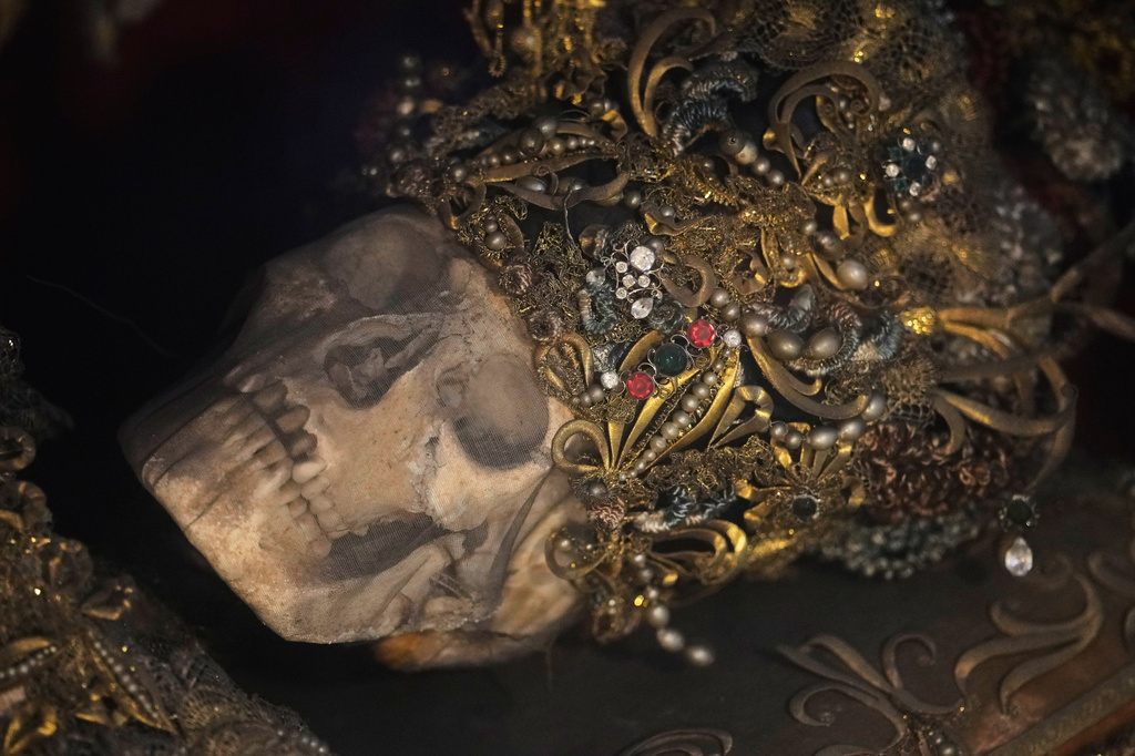 An elaborately decorated skeleton lies in the catholic monastery church of Banz in Bad Staffelstein, Germany, Saturday, May 2, 2026. (AP Photo/Matthias Schrader)