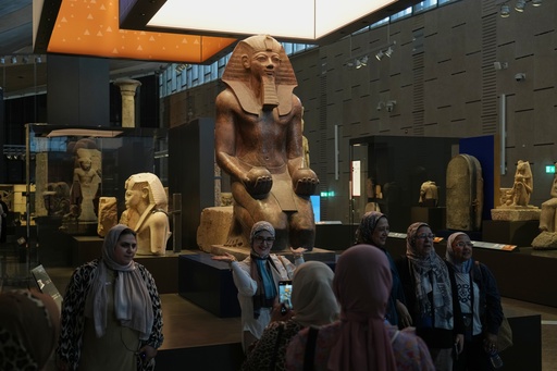 Visitors pose for a group photo under Hatshepsut statue, at the Grand Egyptian Museum in Giza, Egypt, Friday, May 23, 2025. (AP Photo/Amr Nabil) Visitors pose for a group photo under Hatshepsut statue, at the Grand Egyptian Museum in Giza, Egypt, Friday, May 23, 2025. (AP Photo/Amr Nabil)