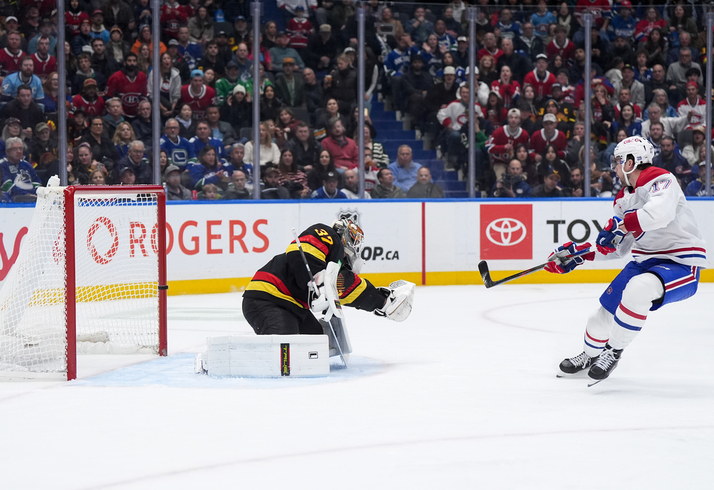 Montreal Canadiens' Josh Anderson (17) hits the post behind Vancouver Canucks goalie Kevin Lankinen (32) on a breakaway during the second period of an NHL hockey game in Vancouver, on Saturday, Oct. 25, 2025. (Darryl Dyck/The Canadian Press via AP)