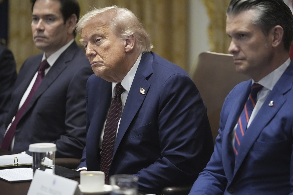 President Donald Trump, Secretary of State Marco Rubio, left, and Secretary of Defense Pete Hegseth, right, listen during a cabinet meeting. Tuesday, Aug. 26, 2025, at the White House in Washington. (AP Photo/Mark Schiefelbein)