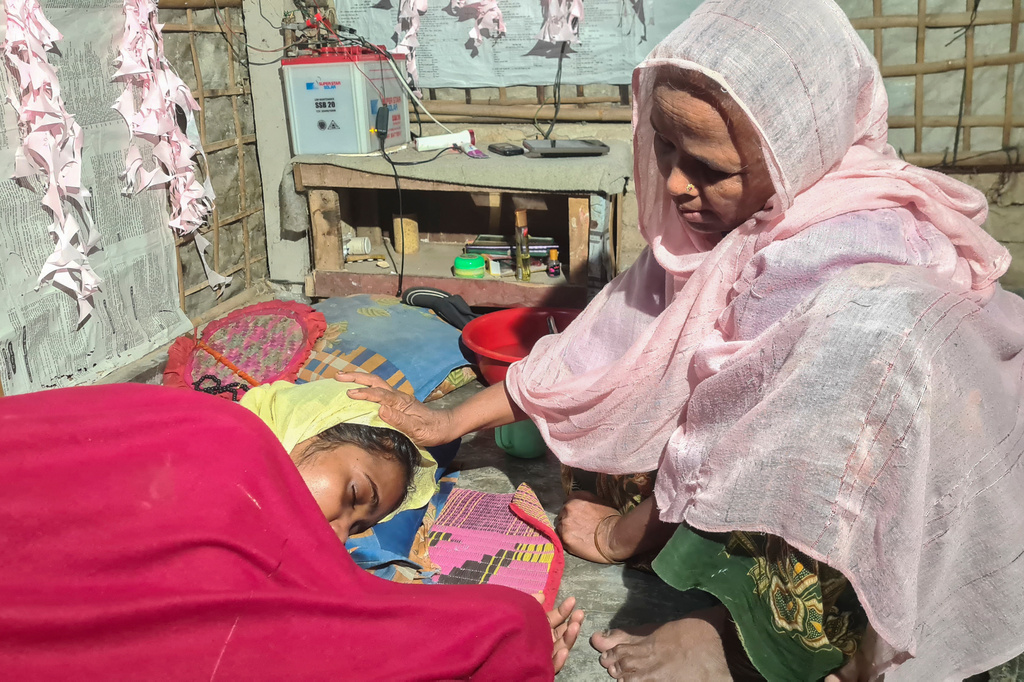 Majuma Khatun, the mother of Rahela Begum, a Rohingya survivor, comforts her at their shelter after she was rescued on April 9, 2026 from a capsized boat, at a refugee camp in Cox's Bazar, Bangladesh, Wednesday, April 15, 2026. (AP Photo/Suzauddin Rubel)