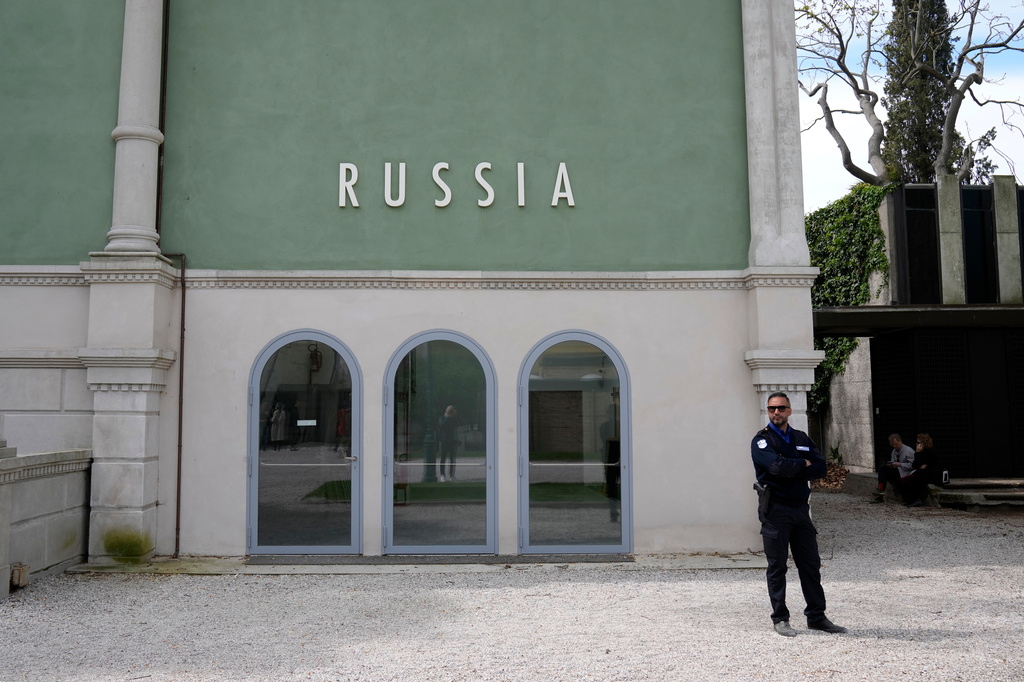 FILE - A private security officer stands next to a closed Russia's pavilion at the 59th Biennale of Arts exhibition in Venice, Italy, Tuesday, April 19, 2022. (AP Photo/Antonio Calanni, File)