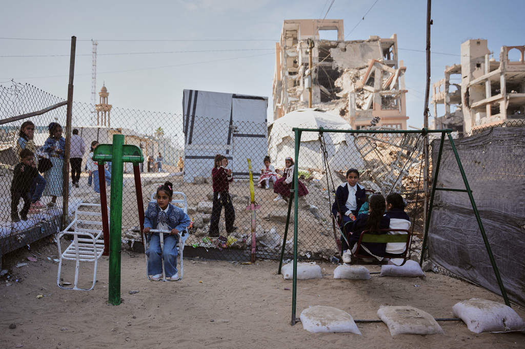 FILE - Displaced Palestinian children play on a swing at a tent camp as they mark the Muslim holiday of Eid al-Fitr in Gaza City, Friday, March 20, 2026. (AP Photo/Abdel Kareem Hana, file)
