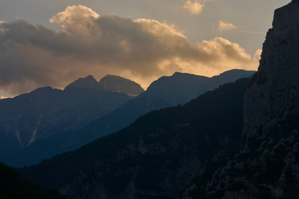 The setting sun illuminates the clouds above Mytikas and Stefani, the highest peaks of Mount Olympus in northern Greece, Tuesday, July 14, 2026. (AP Photo/Petros Giannakouris)