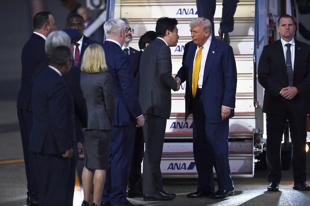 President Donald Trump is welcomed by Japan's newly appointed Chief Cabinet Secretary Minoru Kihara upon arrival at Haneda Tokyo International Airport in Tokyo, Japan, Monday, Oct. 27, 2025, (David Mareuil/Pool Photo via AP)
