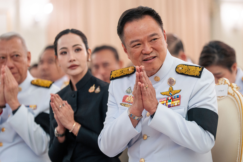 Thailand's Prime Minister Anutin Charnvirakul, right, gestures as he attends an event at the Government House in Bangkok, Thailand, Friday, Dec. 12, 2025. (AP Photo/Arnun Chonmahatrakool)