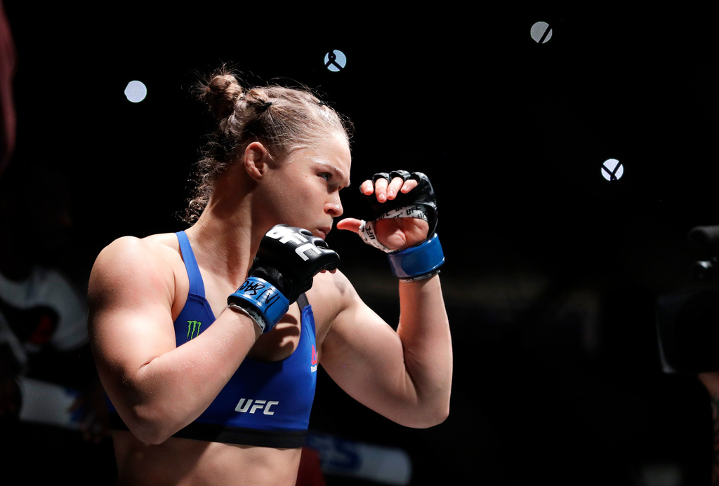 FILE - Ronda Rousey holds up her hands before her women's bantamweight championship mixed martial arts bout with Amanda Nunes at UFC 207, Dec. 30, 2016, in Las Vegas. (AP Photo/John Locher, File)