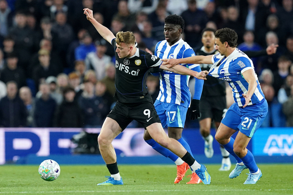 Chelsea's Liam Delap, left, and Brighton and Hove Albion's Olivier Boscagli battle for the ball during the English Premier League soccer match between Brighton & Hove Albion and Chelsea in Brighton, England, Tuesday, April 21, 2026. (Gareth Fuller/PA via AP)