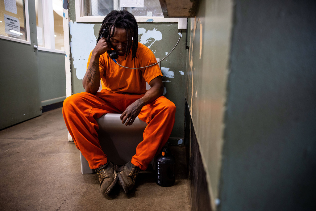 Timothy Woods talks on the phone at the Pine Grove Youth Conservation Camp, July 14, 2025, in Red Corral, Calif. (AP Photo/Ethan Swope)