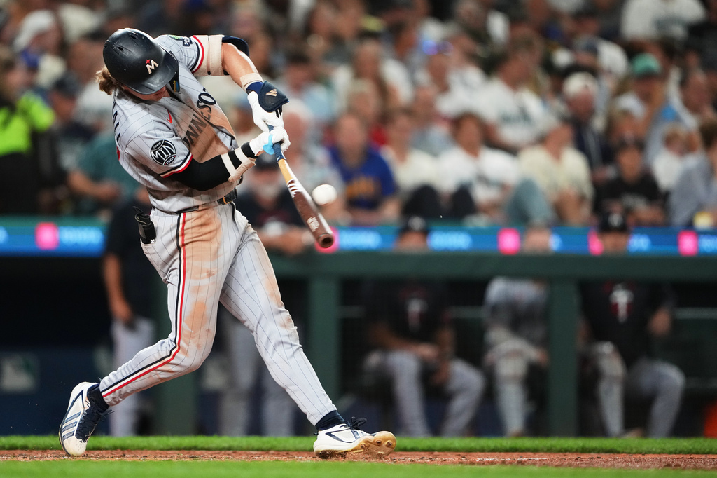 Minnesota Twins' Luke Keaschall hits an RBI double against the Seattle Mariners during the seventh inning of a baseball game, Friday, July 31, 2026, in Seattle. (AP Photo/Lindsey Wasson)
