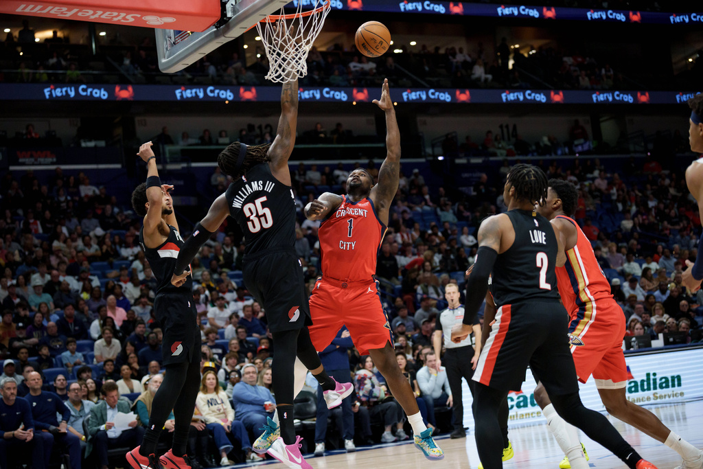 New Orleans Pelicans forward Zion Williamson (1) shoots against Portland Trail Blazers center Robert Williams III (35) during the first half of an NBA basketball game in New Orleans, Friday, Jan. 2, 2026. (AP Photo/Matthew Hinton)