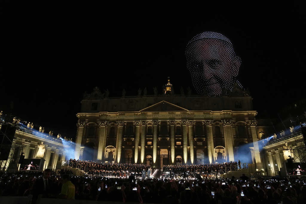An image of Pope Francis made by drones, hovers over the basilica in St. Peter's Square during a concert marking the conclusion of the World Meeting on Human Fraternity, at the Vatican, Saturday, Sept. 13, 2025. (AP Photo/Gregorio Borgia)