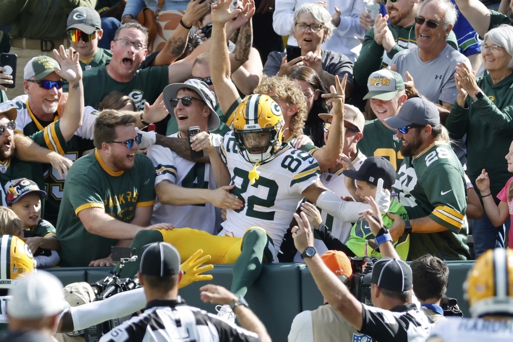 Green Bay Packers' Will Sheppard celebrates his touchdown reception in the stands with fans during the first half of a preseason NFL football game against the Seattle Seahawks Saturday, Aug. 23, 2025, in Green Bay, Wis. (AP Photo/Mike Roemer)