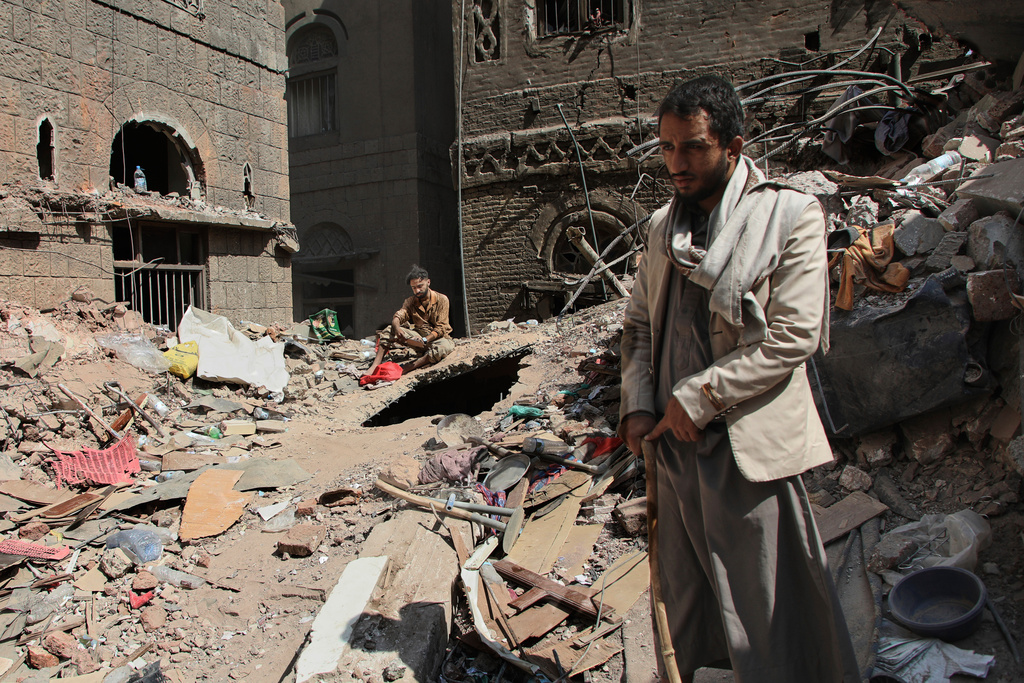 Two Yemeni men inspect the rubble of a house that was destroyed in Wednesday's Israeli airstrikes, in Sanaa, Yemen, Saturday, Sept. 13, 2025. (AP Photo/Osamah Abdulrahman)