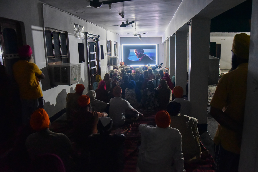 Villagers watch a special screening of the film “Satluj” at a Sikh temple at Tatley village, in Punjab's Gurdaspur district, India, Wednesday, July 8, 2026. (AP Photo/Prabhjot Gill)
