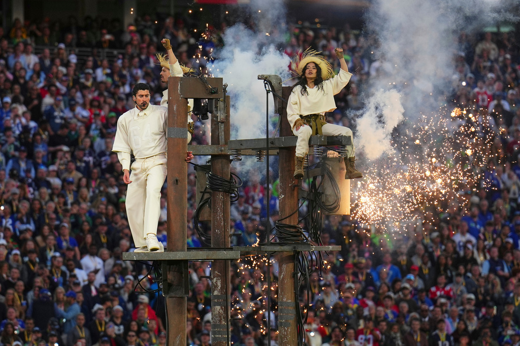 Bad Bunny, left, performs during halftime of the NFL Super Bowl 60 football game between the New England Patriots and the Seattle Seahawks, Sunday, Feb. 8, 2026, in Santa Clara, Calif. (AP Photo/Godofredo A. Vásquez)